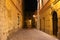 Narrow cobblestone lane with classical houses in historic heart of the city, night view, Krakow, Poland