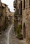 Narrow cobblestone street with massive brown stone houses