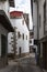 A narrow and cool street with the church bell tower in the background in the town of Villanueva de la Vera in Caceres, Extremadura