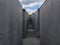 Narrow corridor made of high concrete blocks of the Memorial to the Murdered Jews of Europe in Berlin