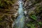 Narrow creek and cliffs covered with moss and fern Rettenbachklamm