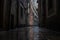 Narrow dark alleyway of buildings during the heavy rain in Barcelona, Spain