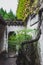Narrow doorway behind trees at Lingering Garden Scenic Area, Suzhou, Jiangsu, China