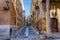 Narrow empty morning street in old part of Tarragona, Spain