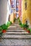 Narrow european street with cobblestone steps and old houses, Po