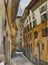 Narrow Florence street in a sunny day original watercolor painting, urban italian illustration, perspective deformation