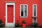 Narrow front door of house in beautiful bright red village house