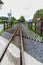 Narrow gauge railway or railroad track converging into distance