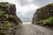 Narrow gravel road between two rocks in Iceland