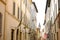 Narrow historic street in Foligno with flags on the facades of the houses. Glimpse in the historic center of the Umbrian town with