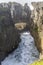 Narrow inlet among worn cliffs at Tasman sea shore, Punakaiki, West Coast, New Zealand