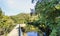 Narrow iron and cement pedestrian bridge over the river Eume wit