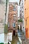 The narrow lane between shabby houses in old Bastia, France