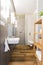 Narrow loft bathroom with wooden floor