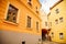Narrow medieval picturesque street with baroque and renaissance historical buildings in sunny summer day, beautiful cityscape of
