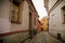 Narrow medieval picturesque street with baroque and renaissance historical buildings in sunny summer day, beautiful cityscape of