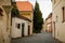 Narrow medieval picturesque street with baroque and renaissance historical buildings in sunny summer day, beautiful cityscape of