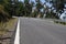 narrow mountain road with a blind curve, Eifel road in summer