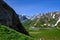 Narrow mountains road from Col de Lautaret to Col du Calibier, Mountains and alpine meadows views of Massif des Ecrins, Hautes