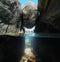 Narrow passage under a boulder wedged between rocks on the sea shore