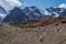 Narrow path along the ridge of the mountain. Atmospheric landscape with rocky mountain wall with pointy top in sunny light. Loose