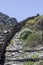 Narrow path with stone stairs in the mountains Cyclades, Andros Island, Greece