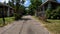 narrow paved road beautiful vintage homes in Florida chain fencing