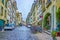 Narrow Postgasse street with scenic arches with plants and resting areas in Bern, Switzerland