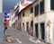 Narrow quiet empty street in funchal madeira with old painted houses on a steep hill with shutters and road signs