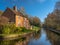 Narrow river surrounded by trees and houses under the sunlight in Ironbridge, England