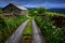 Narrow road, stone fences and old stone house in Yorkshire