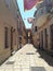 Narrow  romantic street with stone buildings and lanterns,balconies   in old town of Rab Croatia