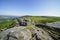 Narrow rutted path threads between gritstone rocks on Baslow Edge