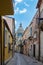 Narrow scenic street in Ragusa with old townhouses and the dome