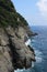 Narrow shot of the mountain rock meets with the blue sea