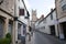 A narrow side street leading to the centre of town in Cirencester, Gloucestershire, UK