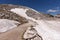 Narrow sidewalk through the snow and scree