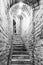 Narrow staircase in old cellar with brick walls