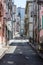 Narrow steep street in San Francisco with clean sidewalks and fire escapes