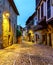 Narrow stone old town alley with cobbled streets.,