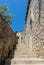 narrow stone stairs between old residential area in croatia. Adriatic coast village with stone houses and Old stone street of