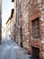 narrow stone street with medieval brick houses
