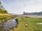 A narrow stream runs through a small bay near Porthmadog at low tide