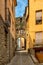 Narrow street with arch at end in medeival town of