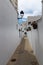 Narrow street with beautiful whitewashed buildings in the old town of Nijar, Andalucia, Spain