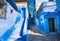 Narrow street of Chefchaouen city in Morocco with blue walls, doors and stairs