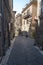A narrow street in the city of Rome, the road of cobblestones and old houses