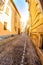 Narrow street between italian houses in old town of Novara