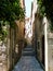 Narrow street on Korcula Island with steps and a view of the cupola of the cathedral