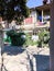 Narrow street, lane, tunnel with old houses, buildings on the sides in a poor area of the city, slums. Vertical photo